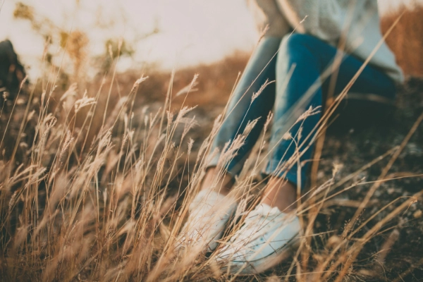 Stylised image of someone sitting in a field