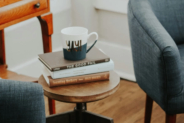Image of a cup of coffee and two chairs
